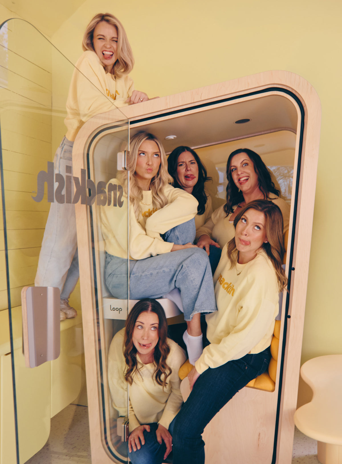Snackish team gathered in a photo booth